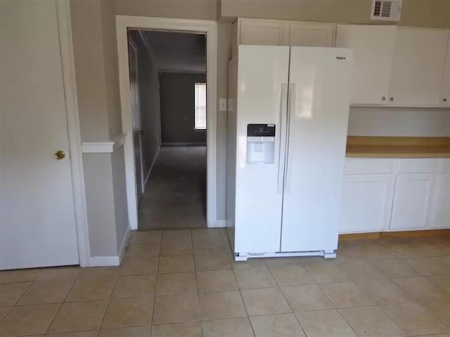 3218 Thirteen Colony Mall Unit 1A, Memphis, TN 38115 - kitchen with white fridge with ice dispenser, white cabinetry, light tile patterned floors, and baseboards