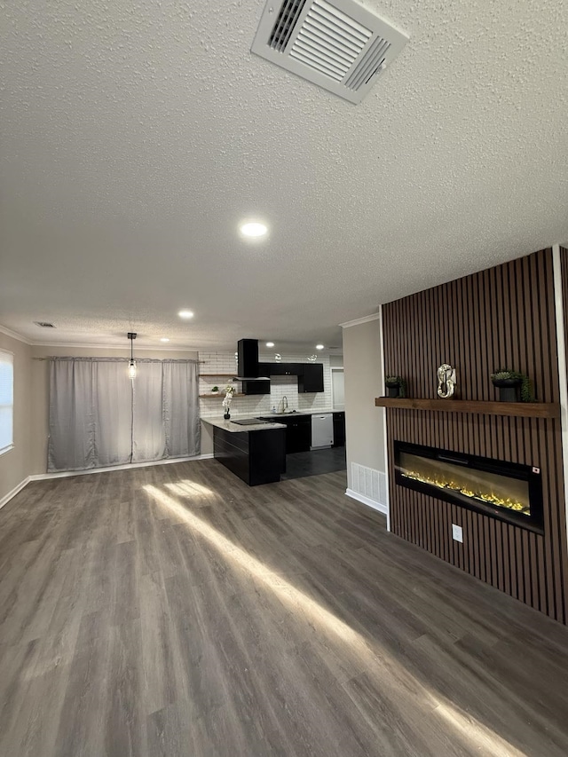 1340 S Perkins Rd, Memphis, TN 38117 - unfurnished living room featuring dark wood-style flooring, recessed lighting, a glass covered fireplace, a textured ceiling, and baseboards