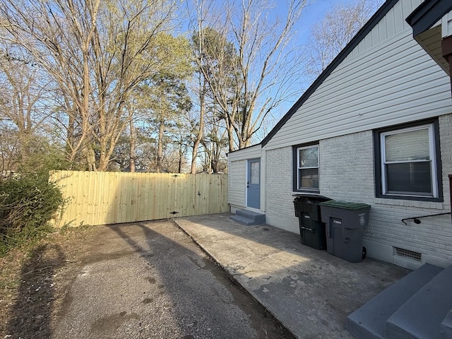 1340 S Perkins Rd, Memphis, TN 38117 - view of home's exterior with brick siding, fence, entry steps, board and batten siding, and a patio