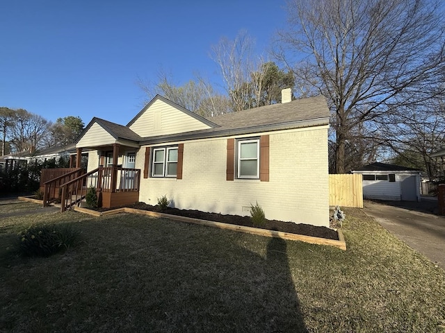 1340 S Perkins Rd, Memphis, TN 38117 - view of front of home featuring brick siding, a chimney, a front yard, and a shingled roof
