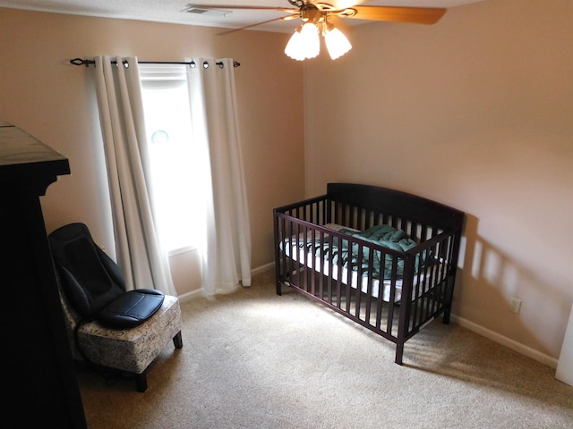 bedroom featuring carpet floors, baseboards, and a ceiling fan
