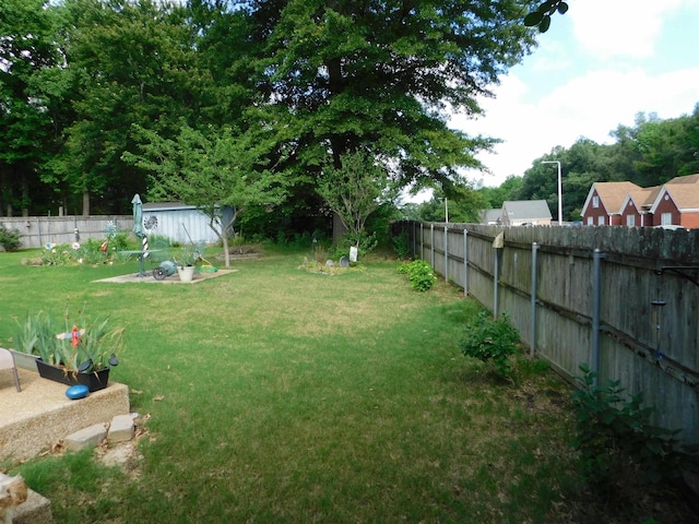 view of yard with a storage shed and an outdoor structure