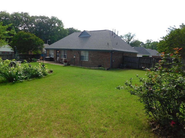 back of house featuring a patio and brick siding