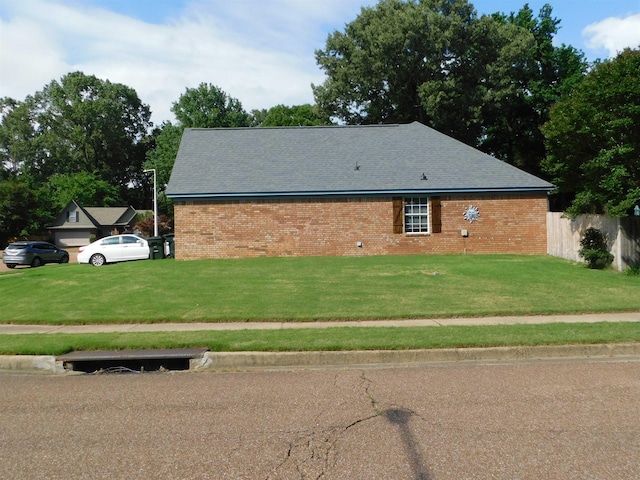 view of side of property with brick siding and a shingled roof