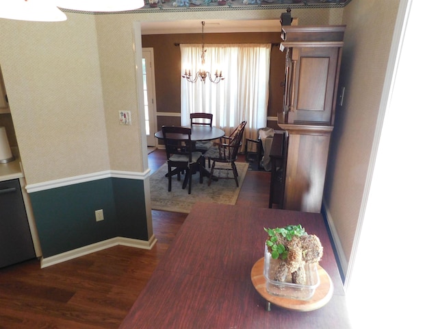 dining area with dark wood-style flooring, a chandelier, and baseboards