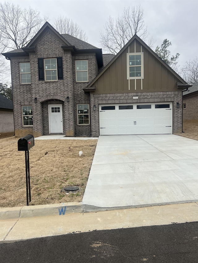 2803 Epping Crest Dr, Memphis, TN 38128 - view of front facade featuring concrete driveway, a garage, brick siding, and board and batten siding