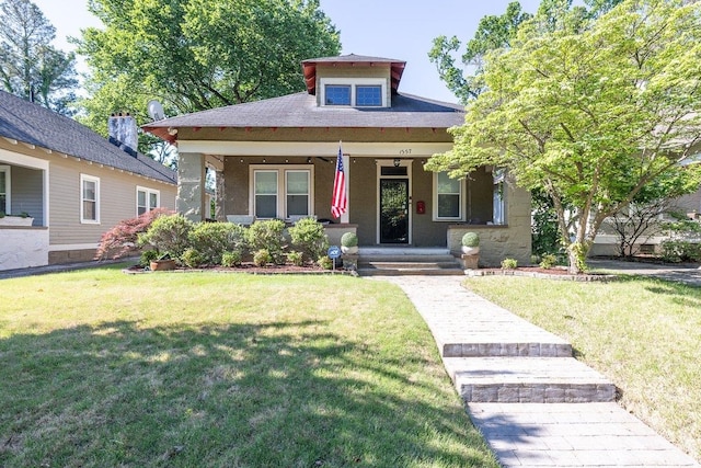view of front of house featuring a porch, a front yard, and stucco siding