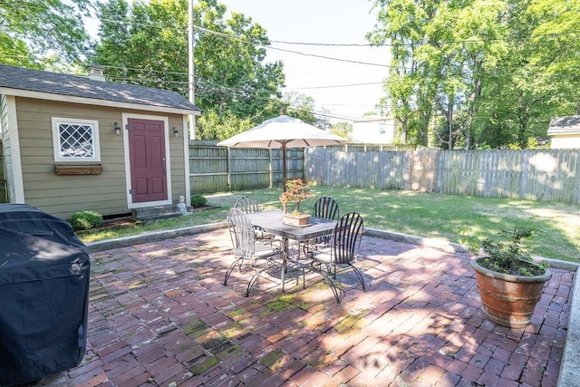 view of patio / terrace featuring outdoor dining area, an outdoor structure, and grilling area