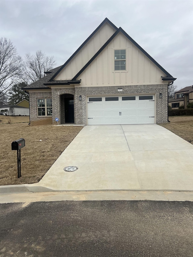 2831 Epping Crest Cv, Memphis, TN 38128 - view of front of house featuring brick siding, concrete driveway, board and batten siding, and an attached garage