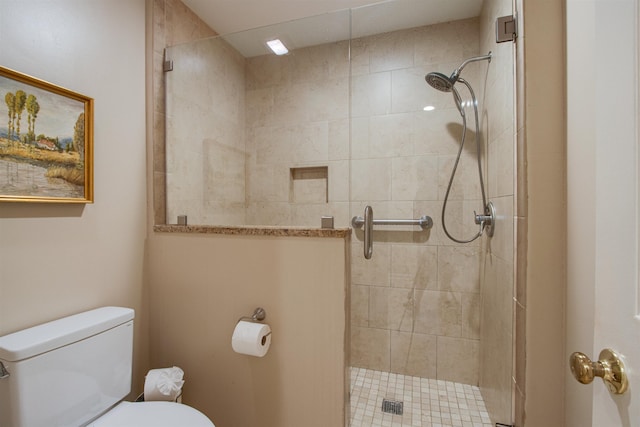 full bathroom with toilet and a shower stall