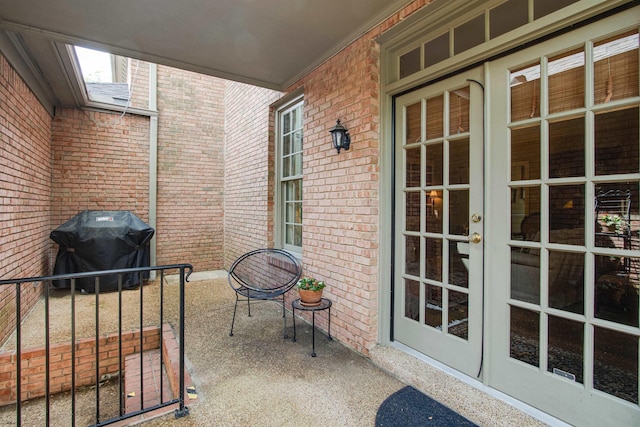 view of patio / terrace with grilling area, french doors, and a porch