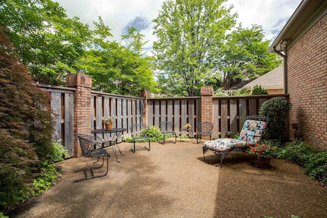 view of patio / terrace featuring fence