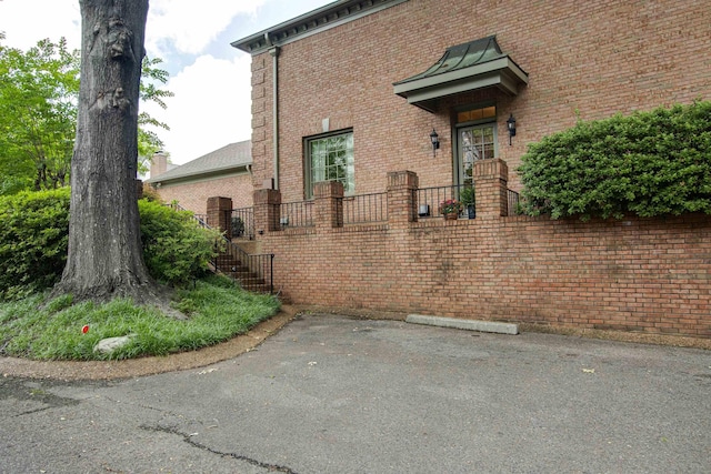 property entrance featuring brick siding