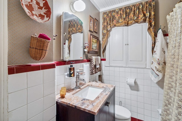 4948 Roane Rd, Memphis, TN 38117 - bathroom with tile walls, toilet, vanity, and wainscoting