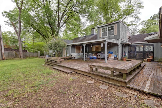 4948 Roane Rd, Memphis, TN 38117 - rear view of property featuring a wooden deck, a chimney, and roof with shingles