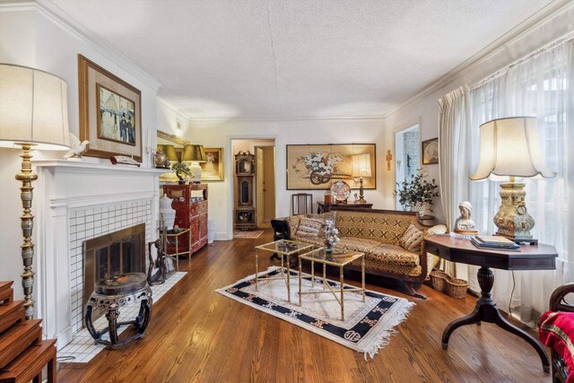 4948 Roane Rd, Memphis, TN 38117 - living area with wood-type flooring, a fireplace, a textured ceiling, and crown molding