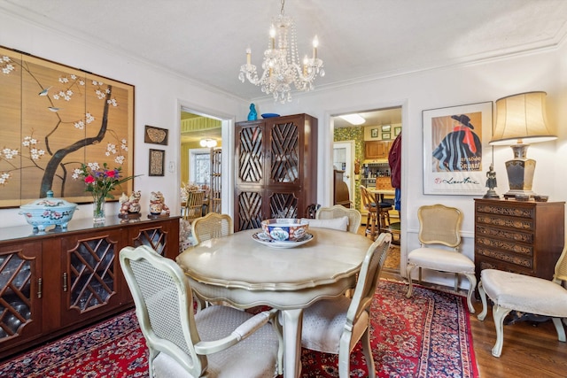 4948 Roane Rd, Memphis, TN 38117 - dining space featuring a chandelier, ornamental molding, and wood finished floors