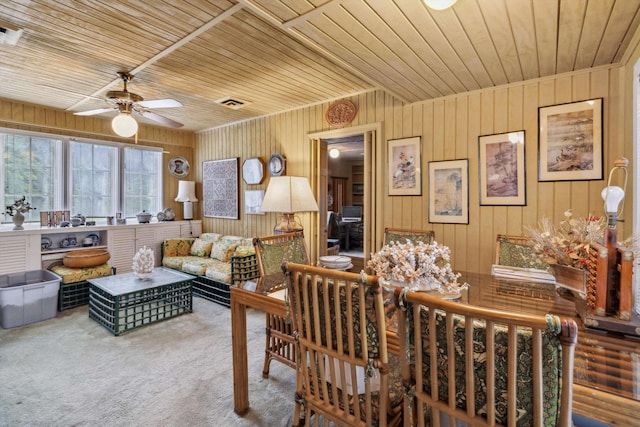 4948 Roane Rd, Memphis, TN 38117 - dining area featuring ceiling fan, carpet flooring, wood ceiling, and wood walls