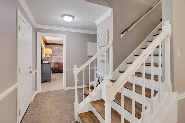 staircase with crown molding and tile patterned floors