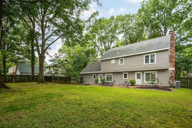 back of house featuring a chimney, a patio area, and central air condition unit