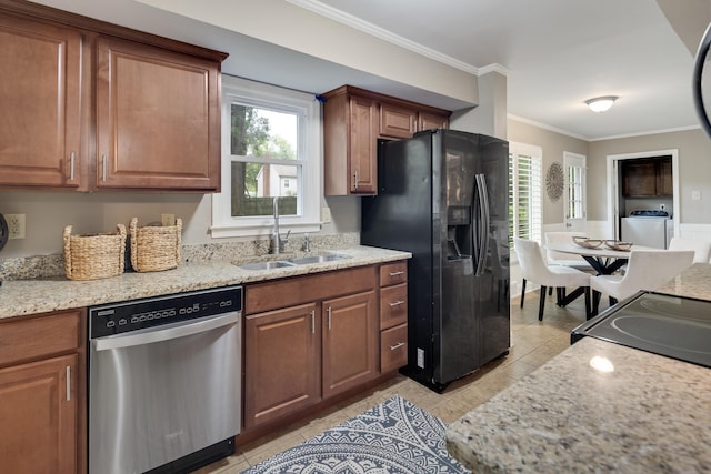 kitchen with black appliances, a sink, washer / clothes dryer, light tile patterned flooring, and ornamental molding
