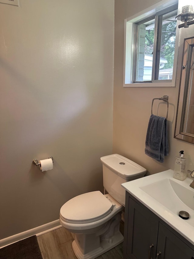 151 N White Station Rd, Memphis, TN 38117 - half bath featuring toilet, vanity, wood finished floors, and baseboards