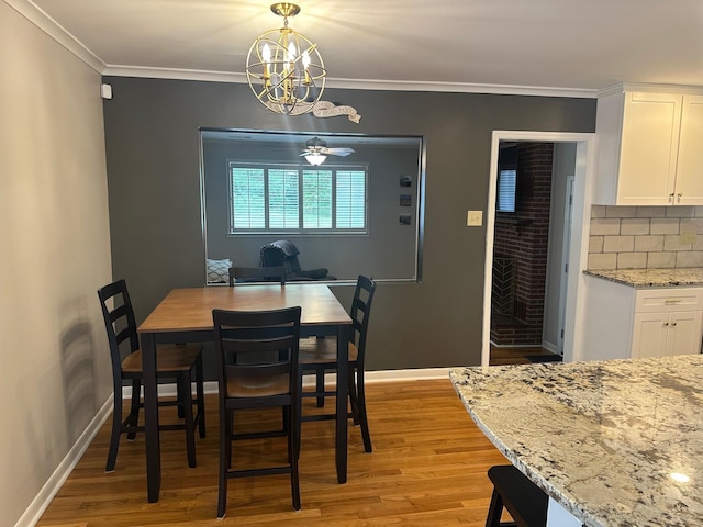 151 N White Station Rd, Memphis, TN 38117 - dining space featuring light wood-style floors, a chandelier, baseboards, and crown molding