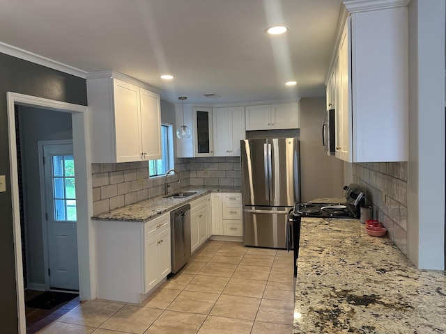 151 N White Station Rd, Memphis, TN 38117 - kitchen with appliances with stainless steel finishes, a sink, white cabinetry, light tile patterned floors, and light stone counters