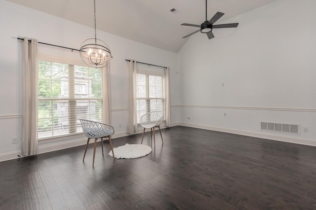 unfurnished dining area featuring a chandelier, dark wood-style floors, baseboards, ceiling fan, and high vaulted ceiling