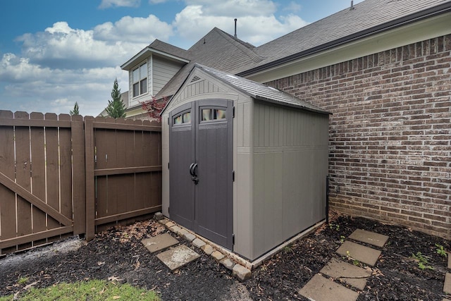 view of shed featuring fence