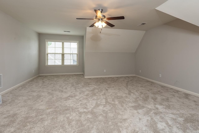 additional living space featuring a ceiling fan, carpet flooring, vaulted ceiling, and baseboards