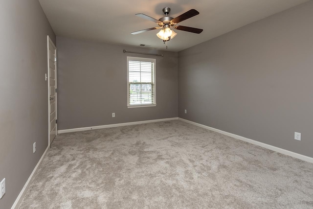 spare room featuring ceiling fan, baseboards, and carpet floors