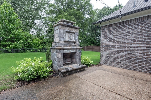 view of patio featuring an outdoor stone fireplace