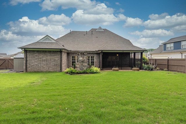 rear view of property with roof with shingles, a sunroom, and brick siding