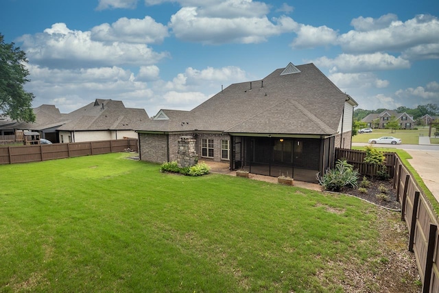 back of house with a sunroom and roof with shingles