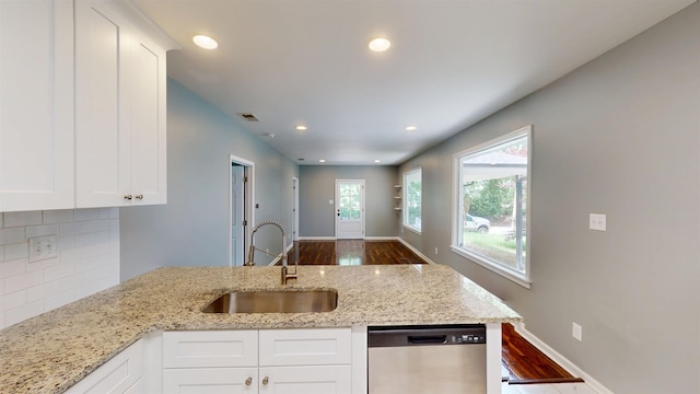 3573 Galloway Ave, Memphis, TN 38122 - kitchen featuring dishwasher, dark wood-style floors, tasteful backsplash, light stone counters, and white cabinets