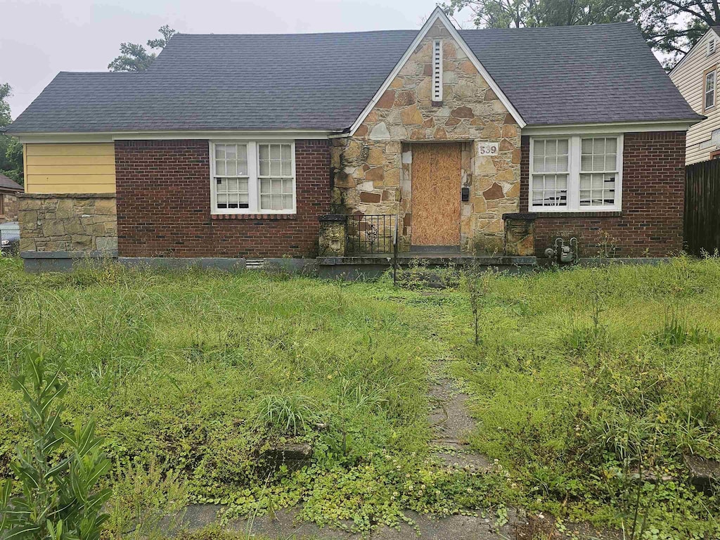 view of front of property with stone siding and brick siding