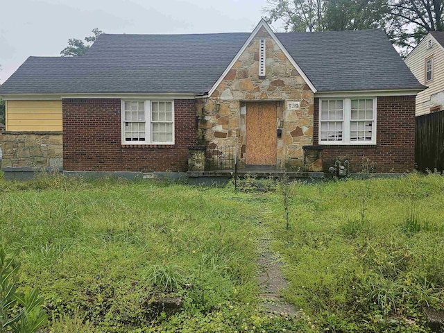 view of front of house with stone siding and brick siding