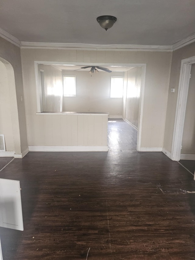 539 Longview Blvd, Memphis, TN 38106 - unfurnished room featuring crown molding, dark wood-style flooring, baseboards, arched walkways, and ceiling fan