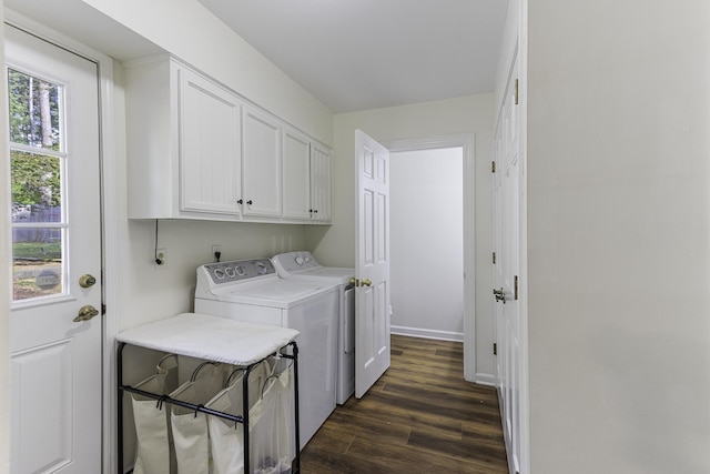 clothes washing area featuring independent washer and dryer, cabinet space, dark wood-type flooring, and baseboards
