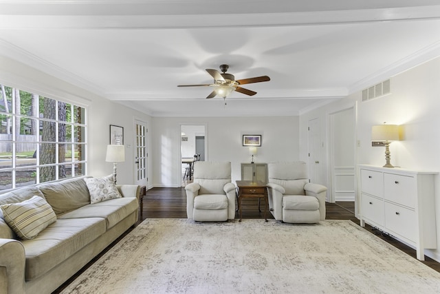 living room with wood finished floors, ornamental molding, ceiling fan, and french doors