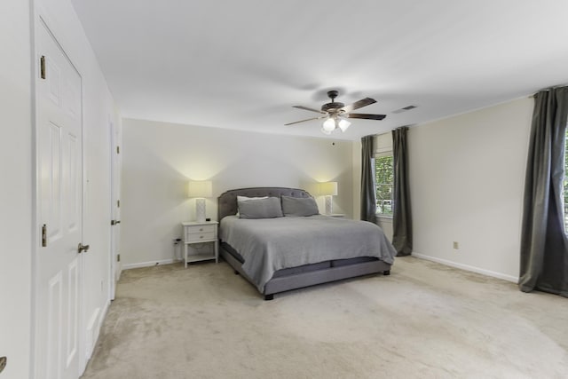 bedroom featuring light carpet, baseboards, and a ceiling fan