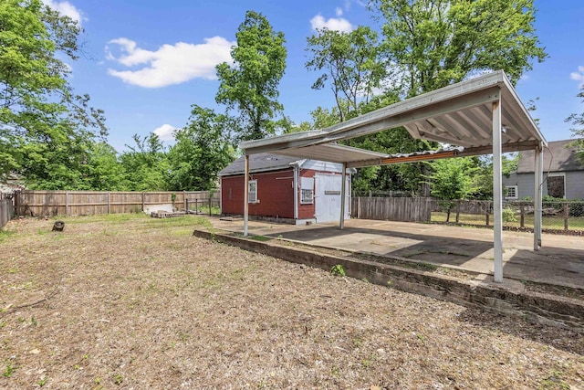686 Looney Ave, Memphis, TN 38107 - fenced backyard with a carport, an outbuilding, and a patio
