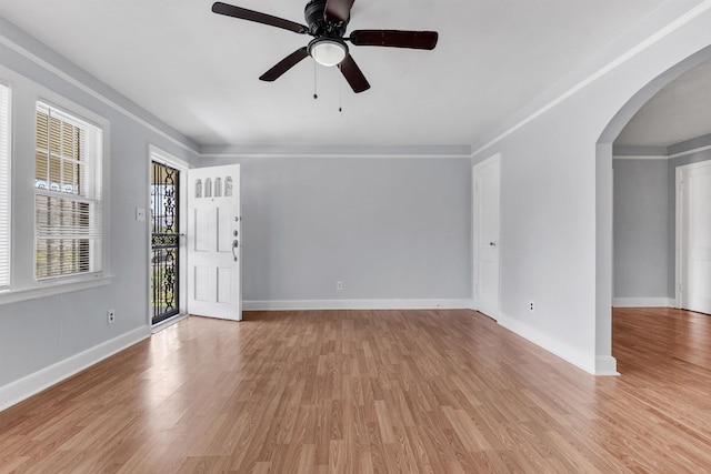 686 Looney Ave, Memphis, TN 38107 - spare room featuring arched walkways, light wood-type flooring, ceiling fan, and baseboards