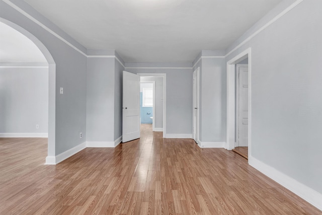 686 Looney Ave, Memphis, TN 38107 - spare room featuring arched walkways, light wood-style floors, and baseboards