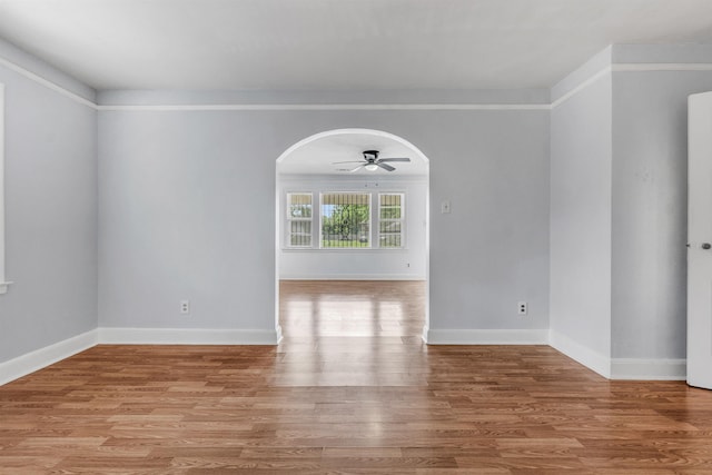 686 Looney Ave, Memphis, TN 38107 - empty room with arched walkways, wood finished floors, ceiling fan, and baseboards