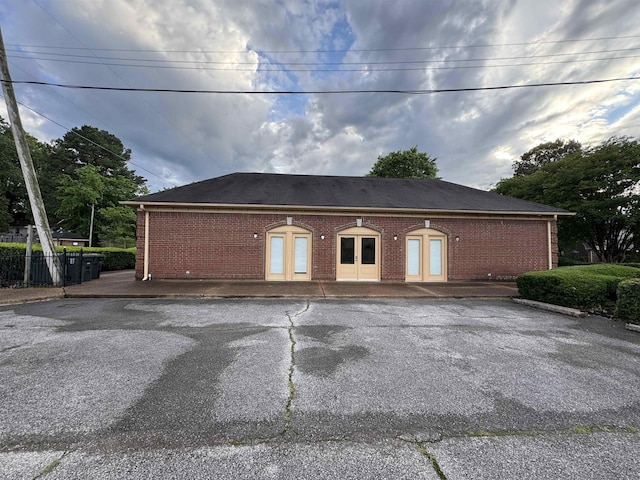 view of front of house with french doors and brick siding