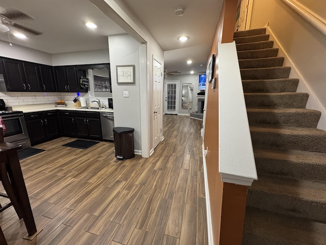 kitchen with ceiling fan, electric range oven, stainless steel dishwasher, dark cabinetry, and recessed lighting