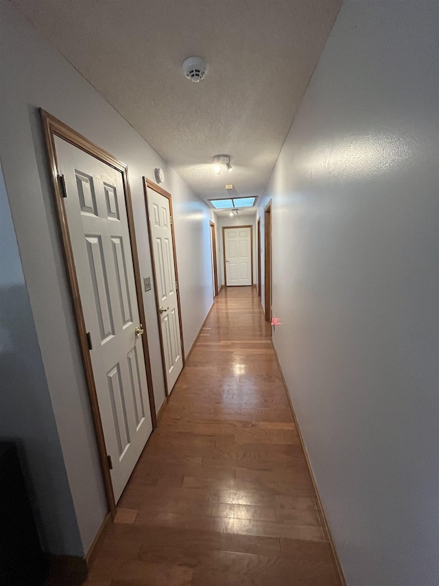 8130 Julie Cv, Millington, TN 38053 - hall with light wood finished floors, a textured ceiling, and baseboards