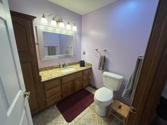 8130 Julie Cv, Millington, TN 38053 - bathroom featuring toilet, a textured ceiling, and vanity